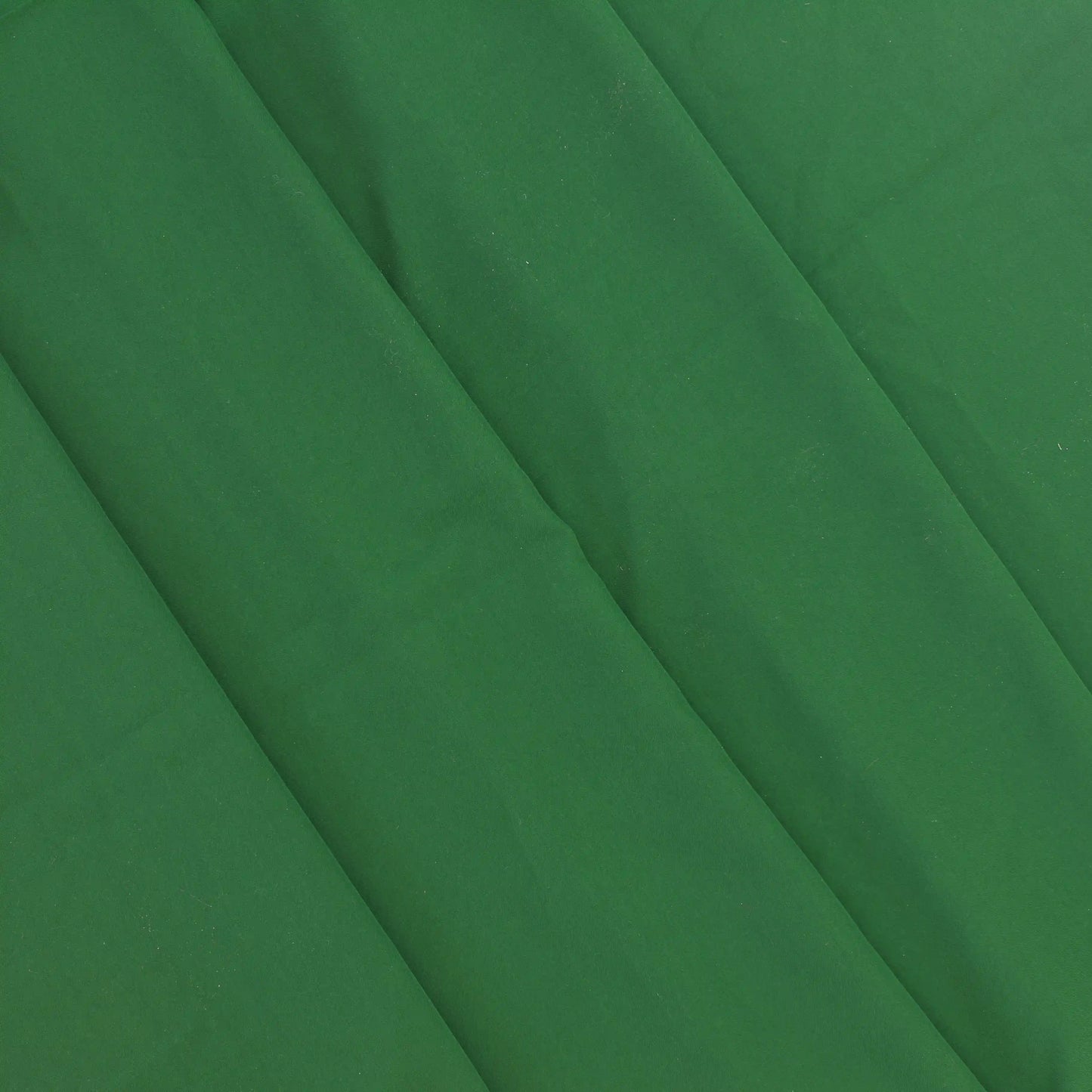 green-polyester-faux-silk-fabric – product laid flat showing its colour and pattern