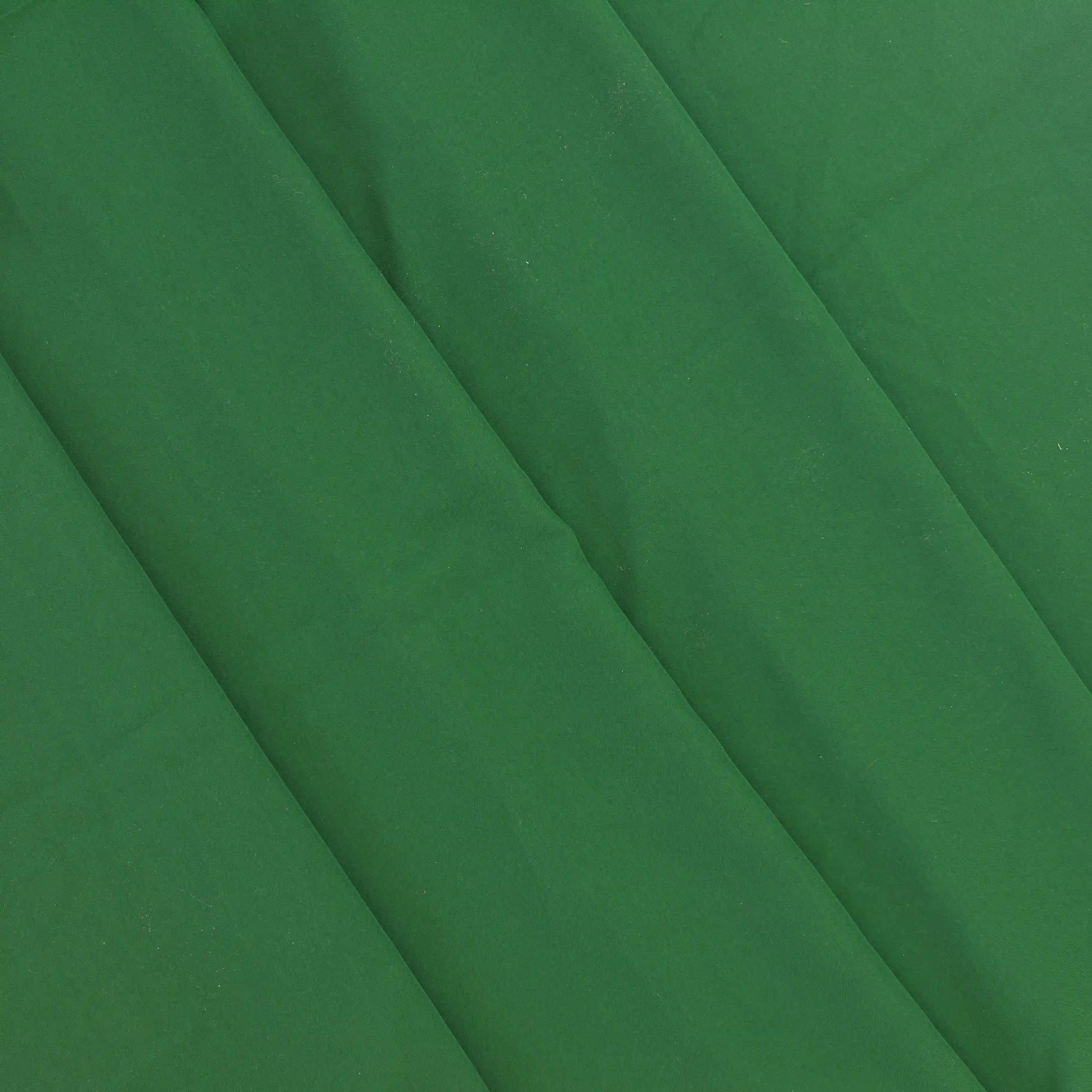 green-polyester-faux-silk-fabric – product laid flat showing its colour and pattern