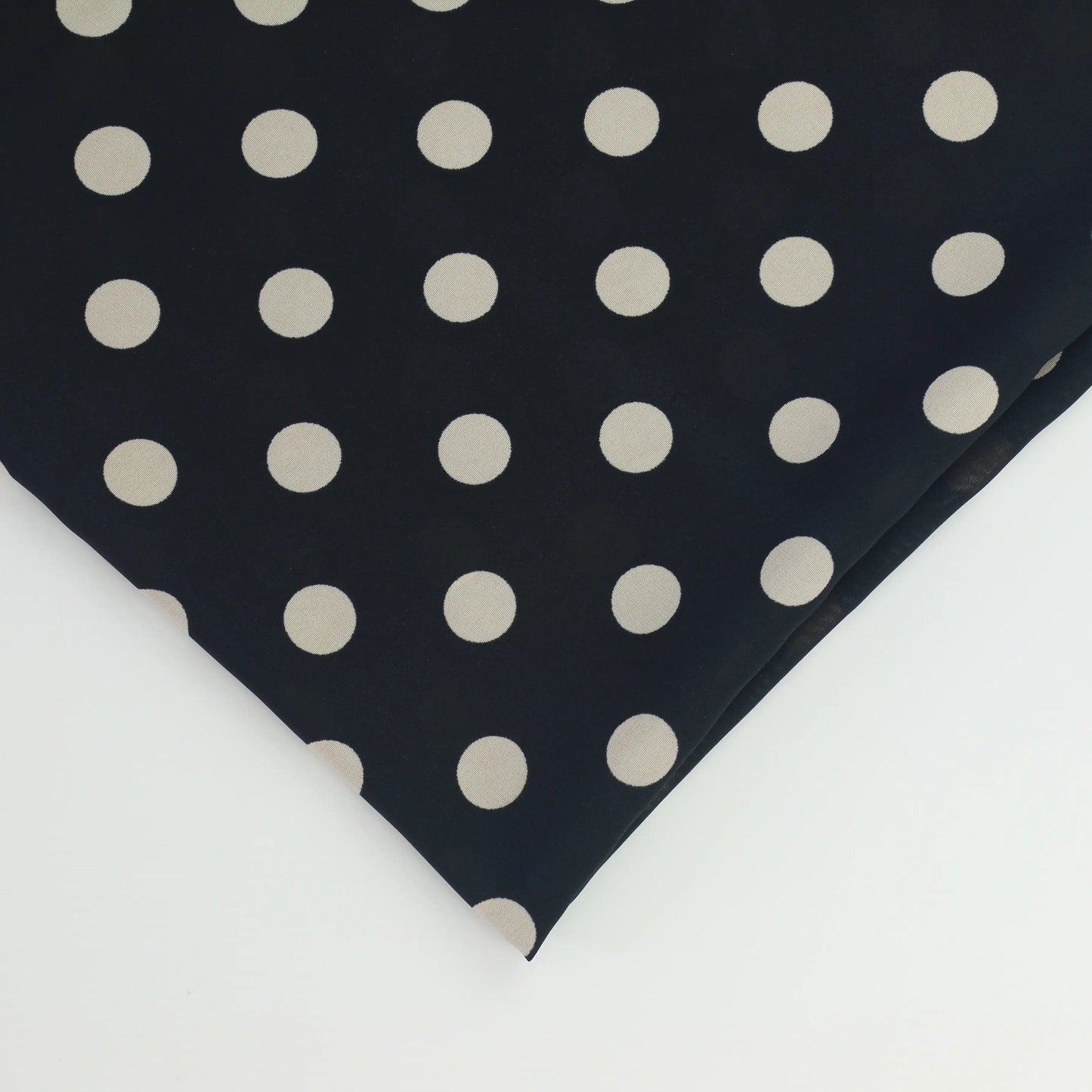 black-&-cream-polka-dot-chiffon-fabric – close-up of colour, pattern and texture