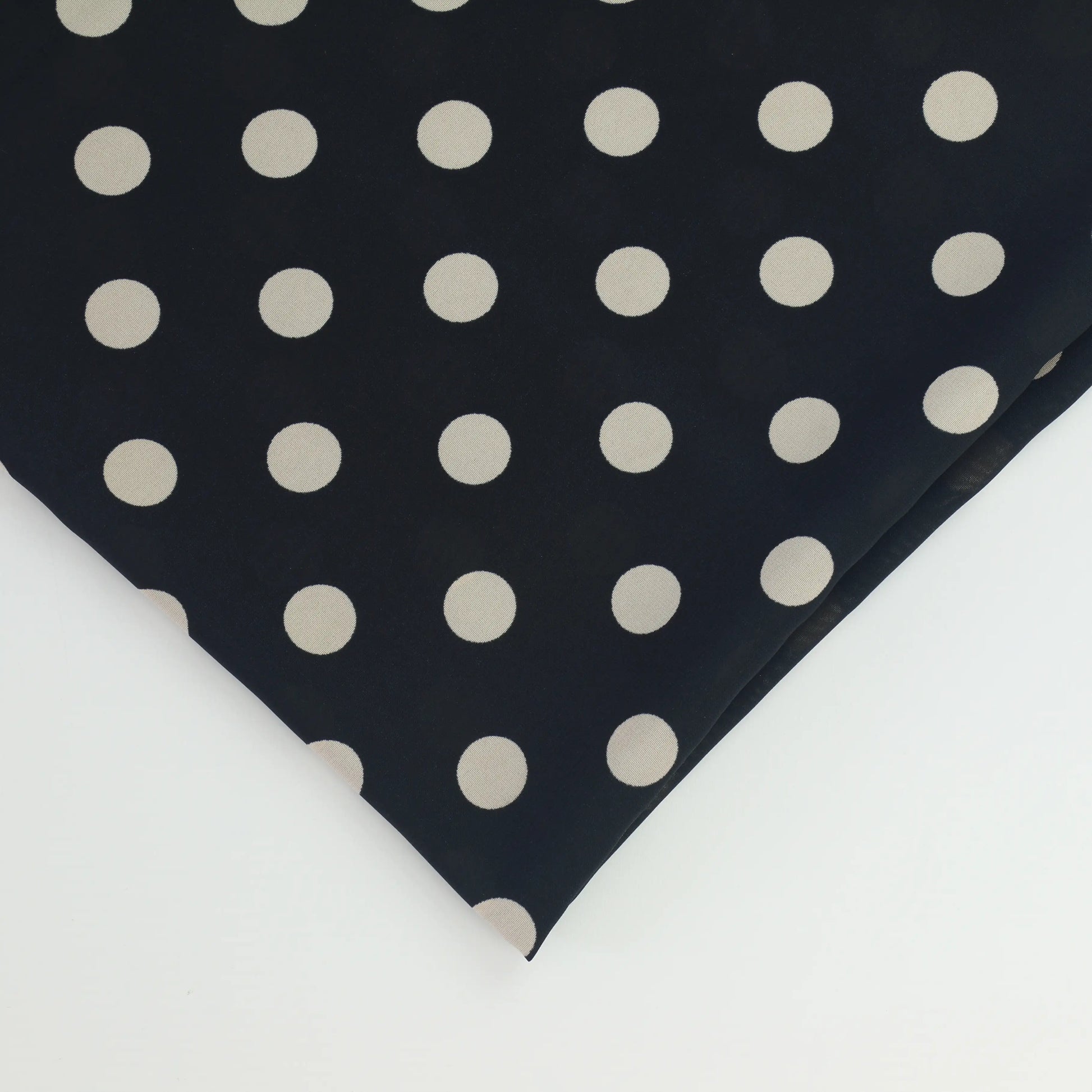 black-&-cream-polka-dot-chiffon-fabric – close-up of colour, pattern and texture