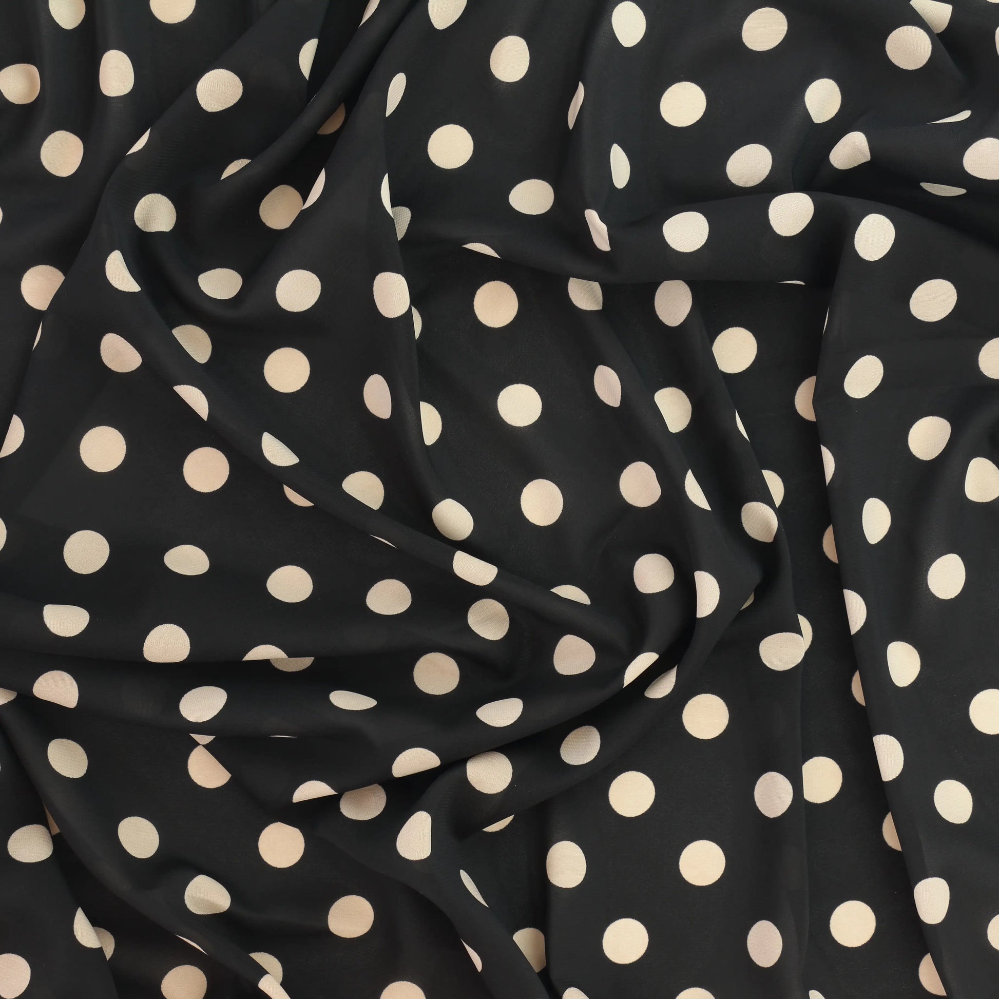 black-&-cream-polka-dot-chiffon-fabric – close-up showing weave and surface detail