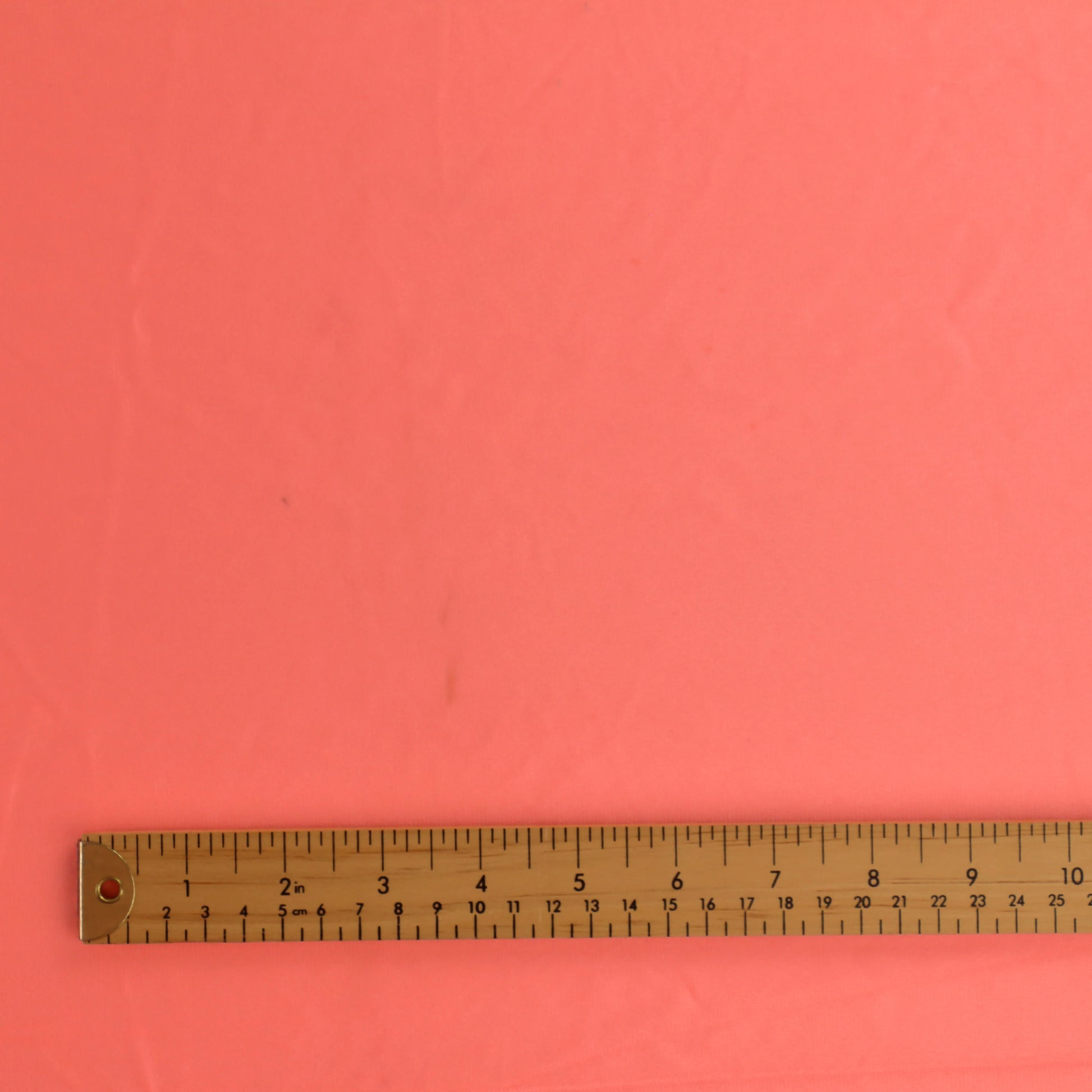 fluoro-peach-duoplex-bra-lining-fabric – close-up of colour, pattern and texture