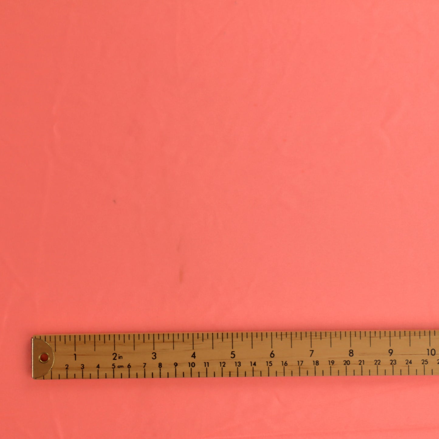 fluoro-peach-duoplex-bra-lining-fabric – close-up of colour, pattern and texture