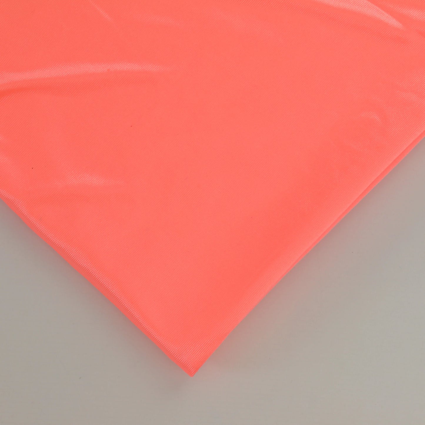 fluoro-peach-duoplex-bra-lining-fabric – close-up showing weave and surface detail