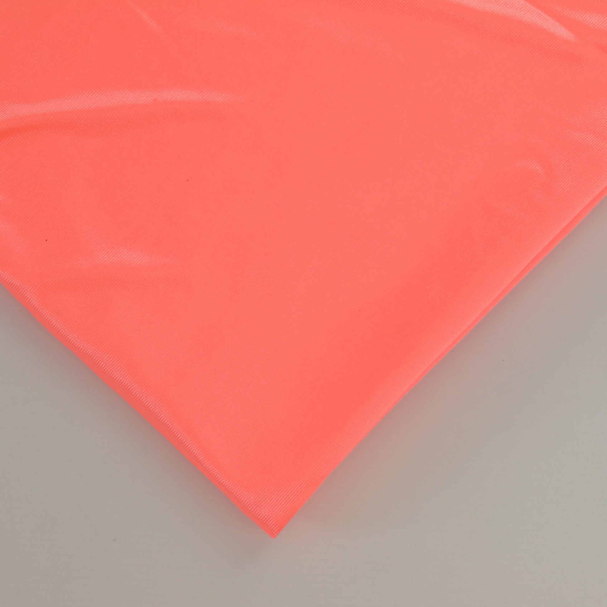 fluoro-peach-duoplex-bra-lining-fabric – close-up showing weave and surface detail