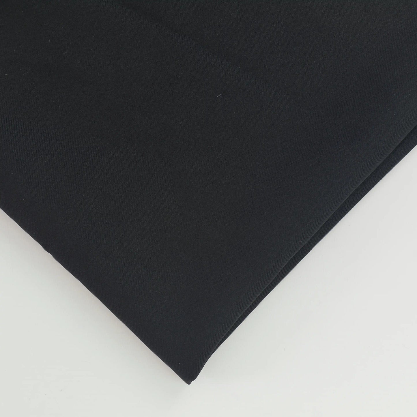 black-polyester-twill-fabric-remnant – close-up of colour, pattern and texture