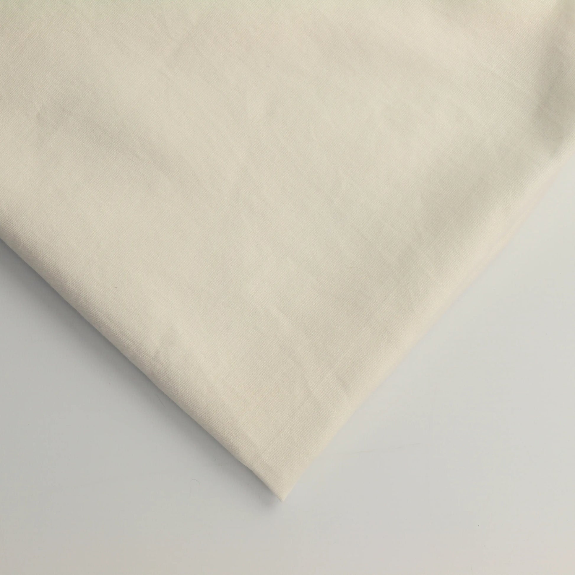 off-white-cotton-sateen-fabric – close-up of colour, pattern and texture