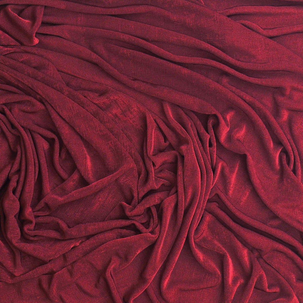 burgundy-polyester-jersey-dressmaking-fabric – product gently folded its colour and texture
