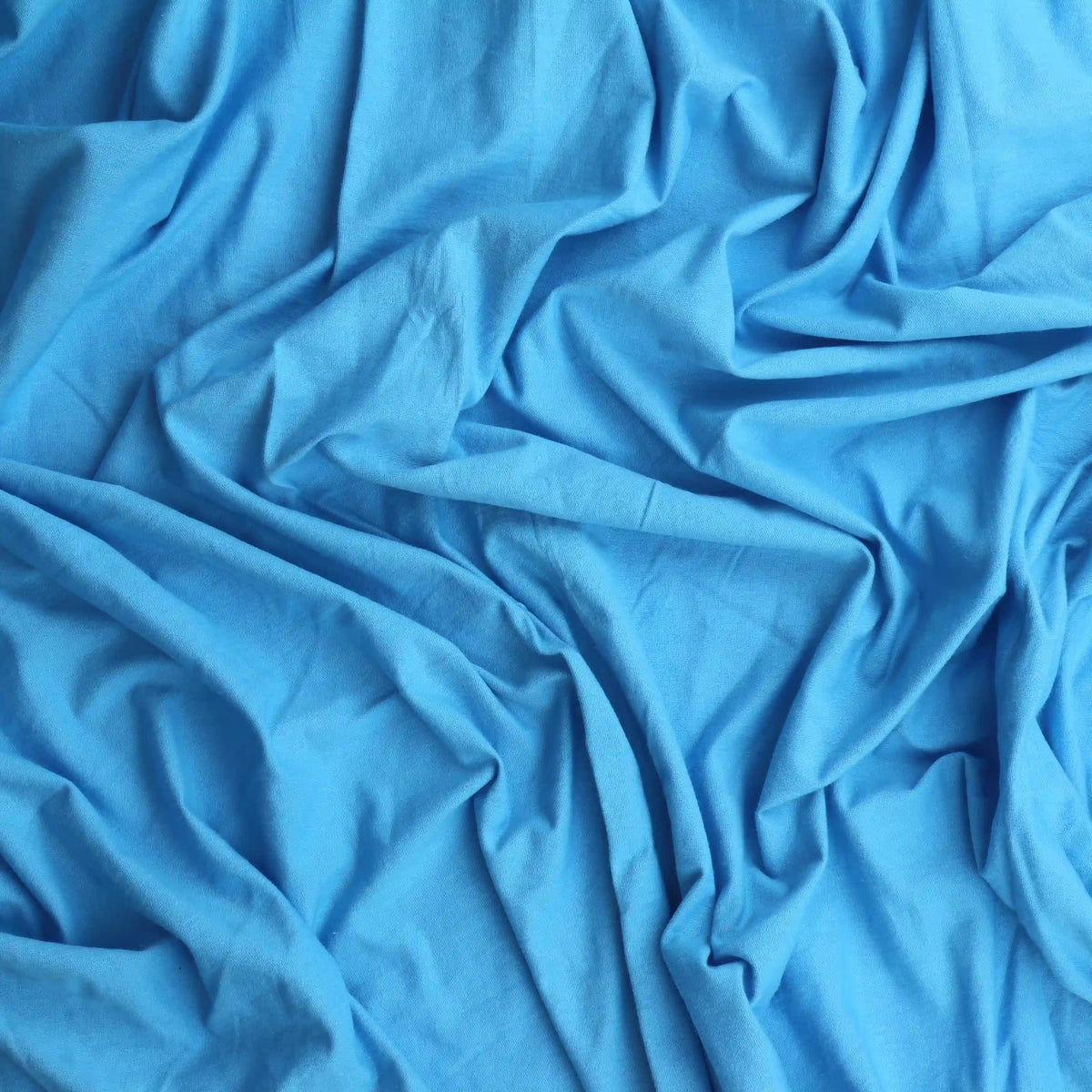 turquoise-cotton-jersey-fabric – product gently folded showing its colour and texture