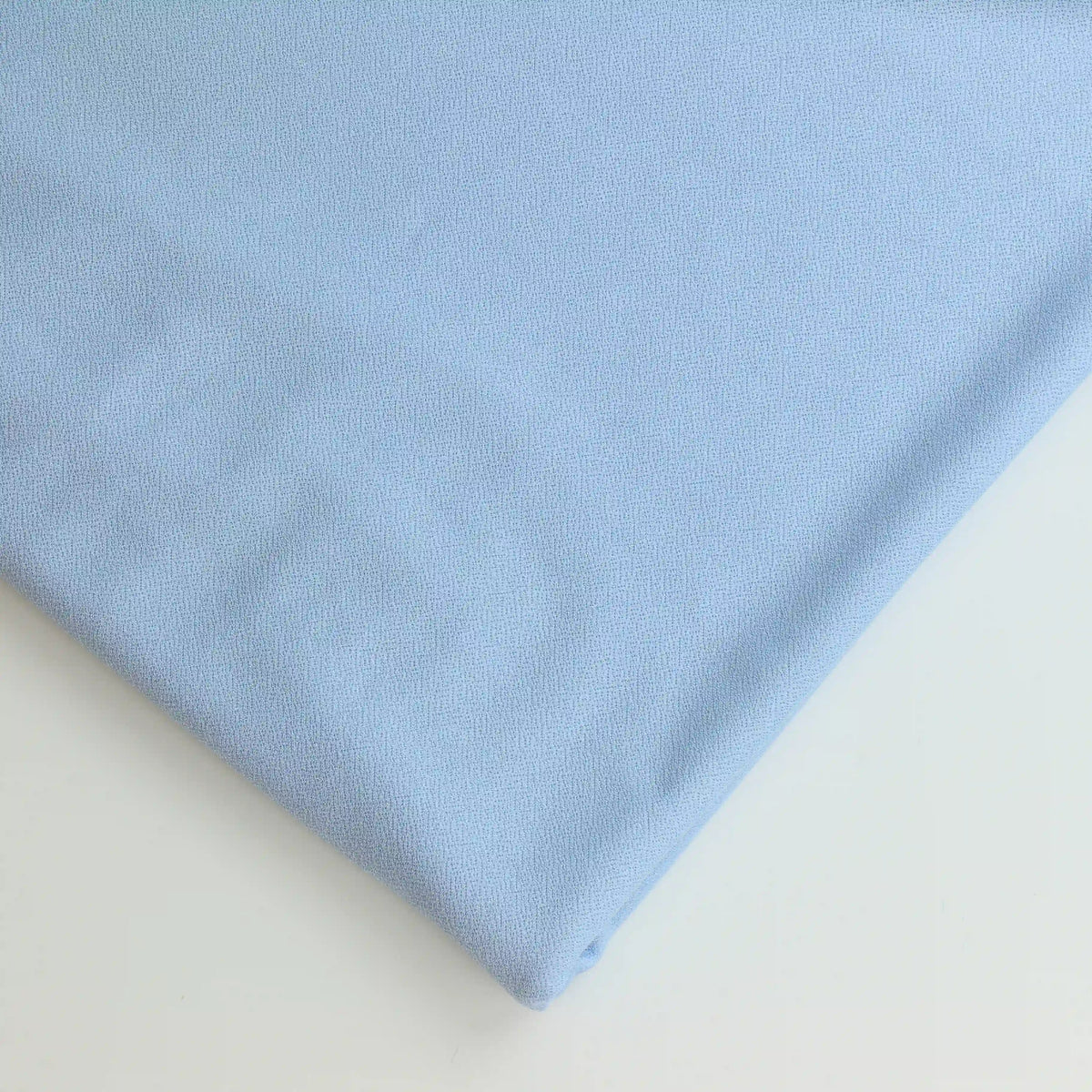 pale-blue-polyester-jersey-fabric – close-up of colour, pattern and texture
