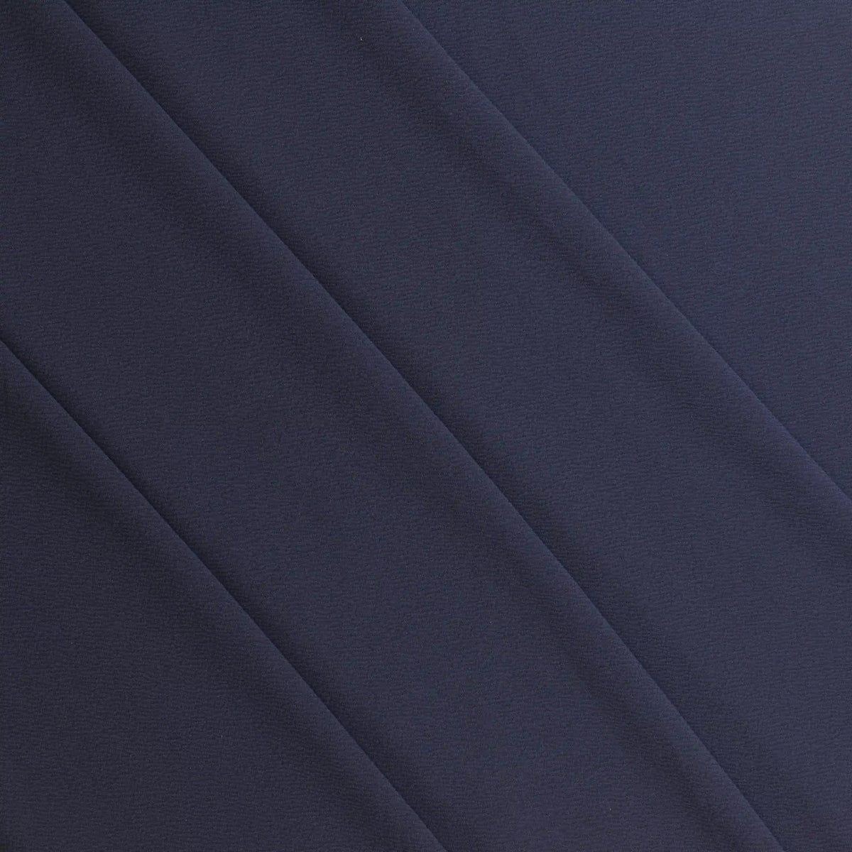 navy-polyester-jersey-fabric – product gently folded showing its colour and pattern