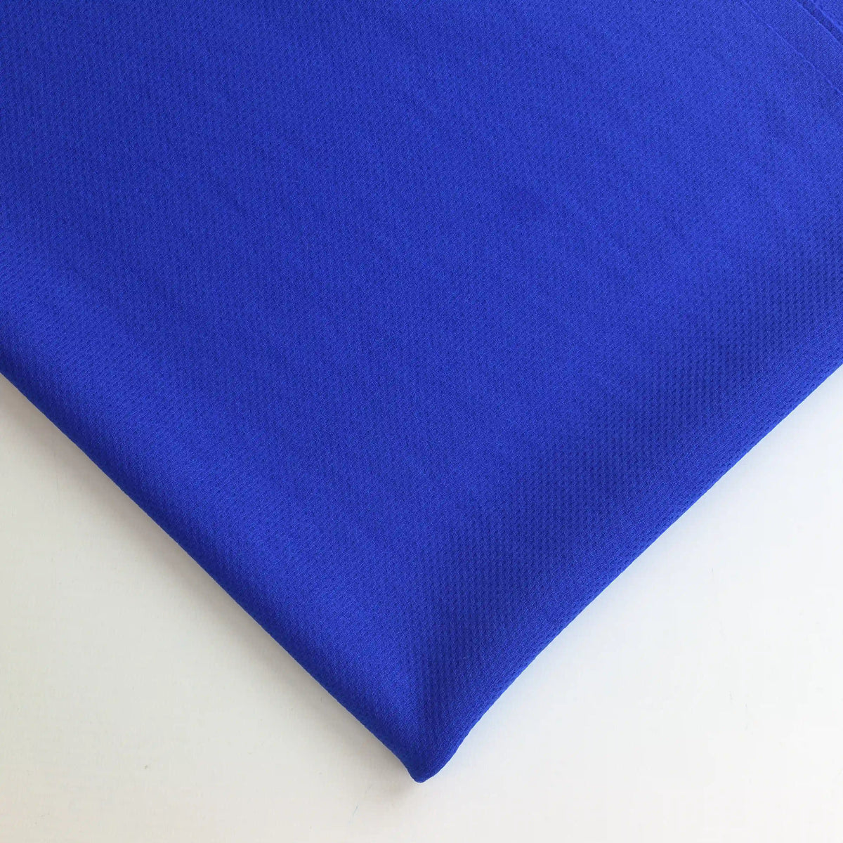 royal-blue--polyester-jersey-fabric-remnant – close-up of colour, pattern and texture