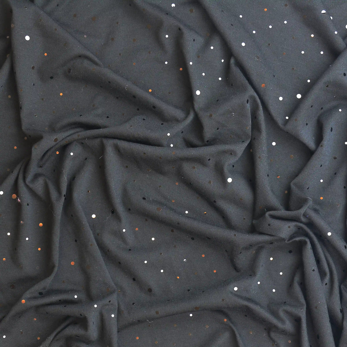 black-sequin-spot-cotton-jersey – product gently folded showing its colour and pattern