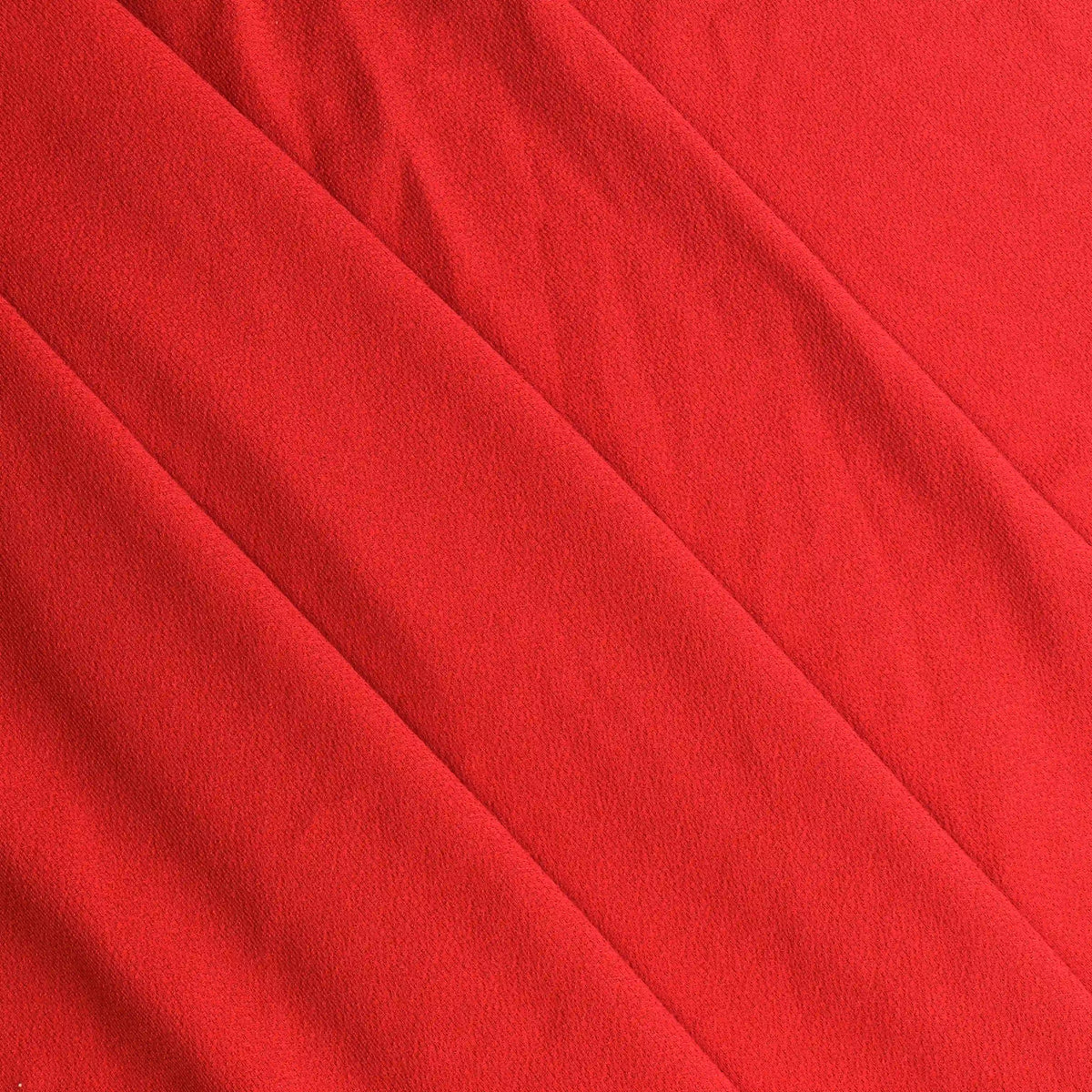 red-polyester-jersey-fabric---2 – product gently folded showing its colour, texture and drape