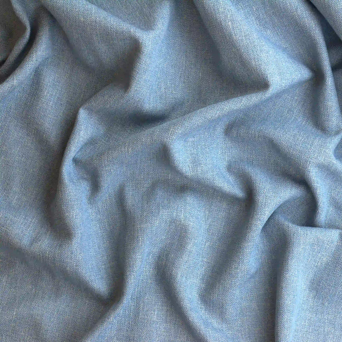 faded-denim-blue-heavyweight-linen-fabric – product gently folded showing its colour and pattern