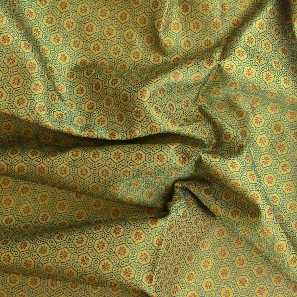 green-gold-geometric-brocade-fabric – close-up of colour, pattern and texture