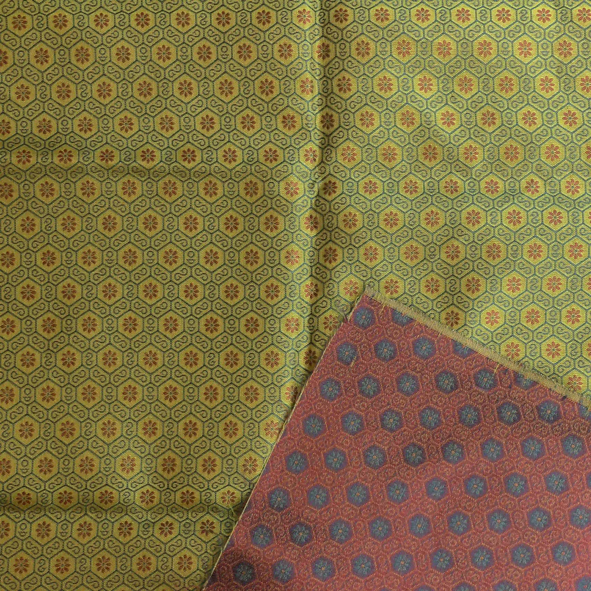 green-gold-geometric-brocade-fabric – close-up showing weave and surface detail