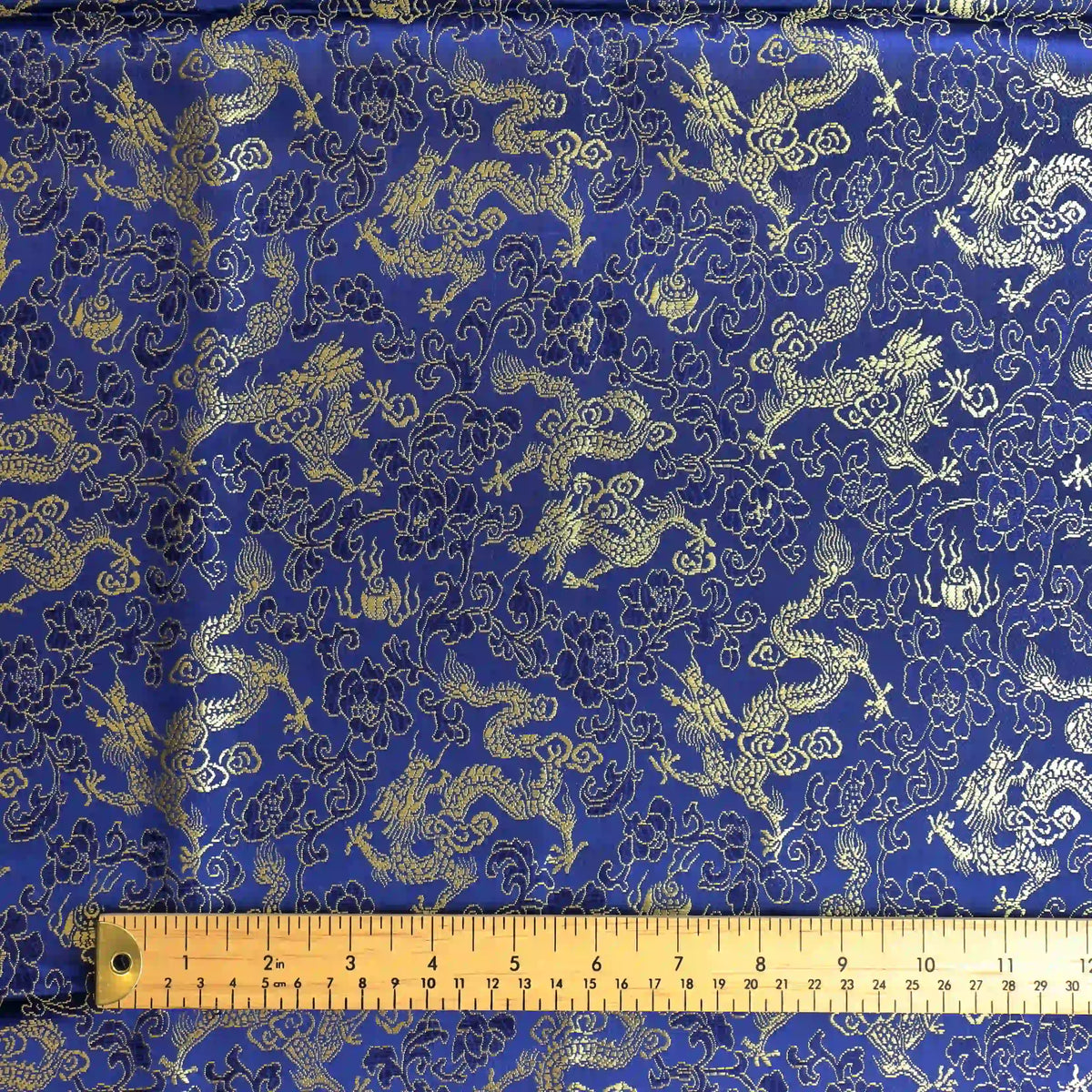 blue-&-gold-floral-dragon-jacquard-fabric – product gently folded showing its colour, texture and drape