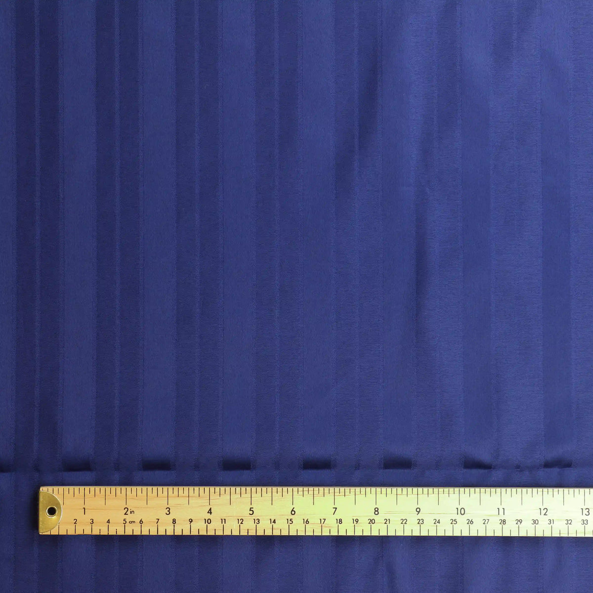 navy-blue-jacquard-stripeed-home-decor-fabric-remnant-1 – product gently folded showing its colour, texture and drape
