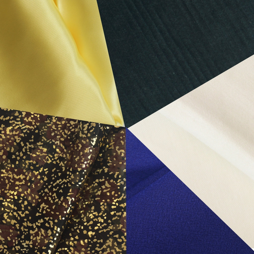Close-up of various fabric swatches including yellow, black, gold, blue, and beige.