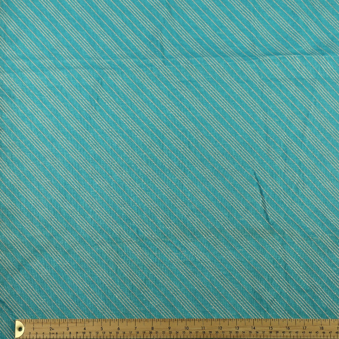 Turquoise & gold striped jacquard fabric laid flat