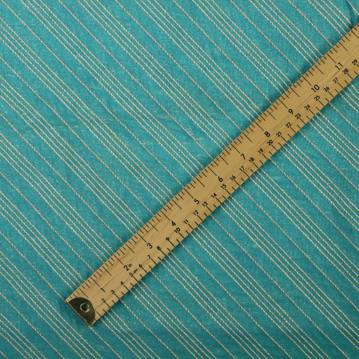 Turquoise & gold striped jacquard fabric laid flat