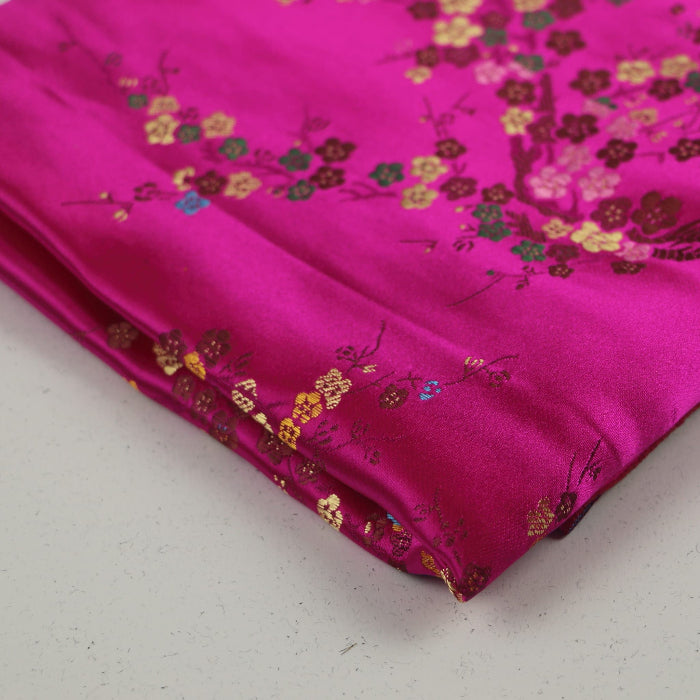 Hot pink cherry blossom jacquard fabric folded showing detail