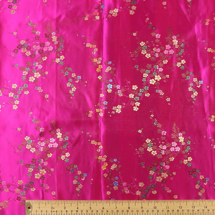Hot pink cherry blossom jacquard fabric laid flat