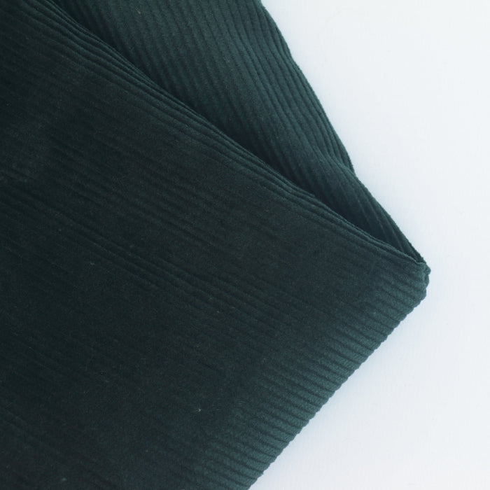 Dark Green Cotton Corduroy Fabric folded showing texture detail
