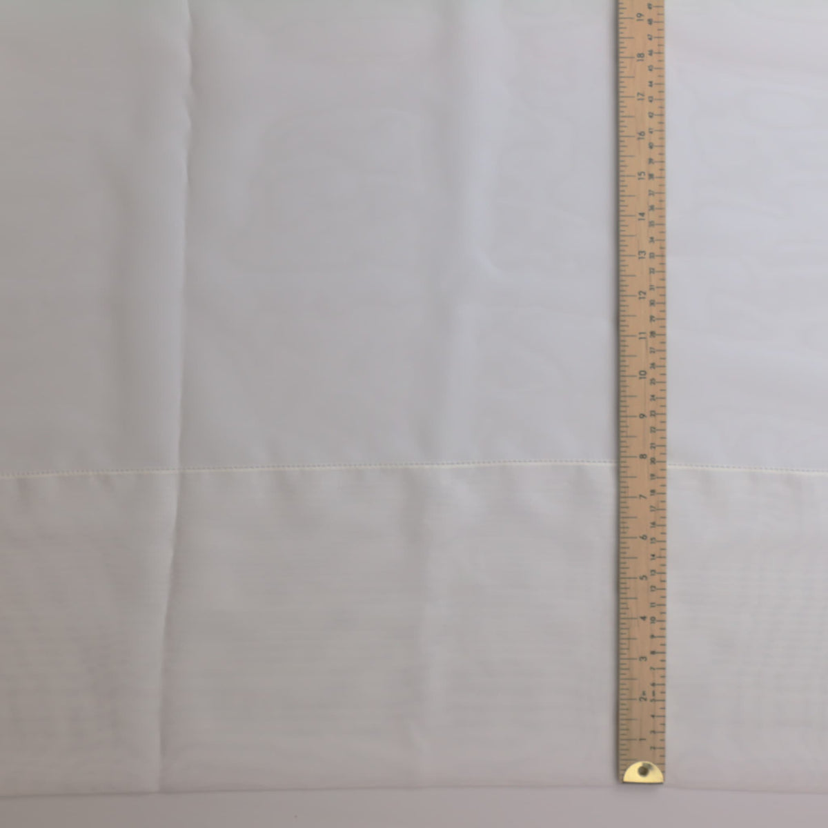 White polyester net curtain fabric laid flat