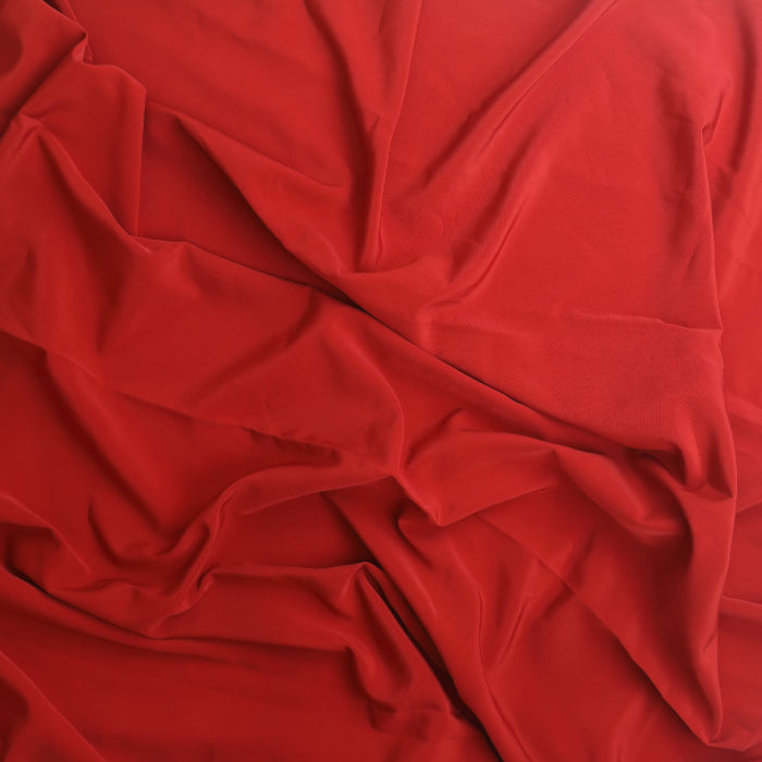 Red polyester twill lining fabric showing drape