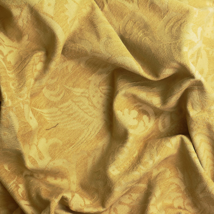 Gold bird print home décor chenille fabric showing drape