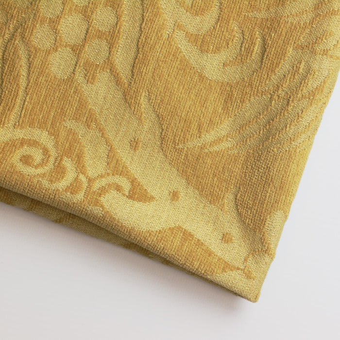 Gold bird print home décor chenille fabric folded showing detail