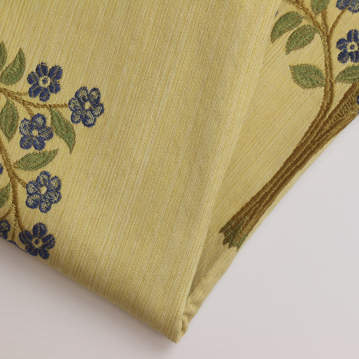 Gold tree print home décor jacquard fabric folded showing detail