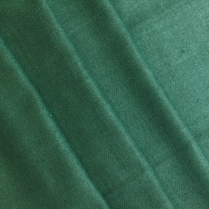 Green herringbone wool coat fabric folded