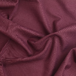 Burgundy polyester viscose twill fabric detail showing drape