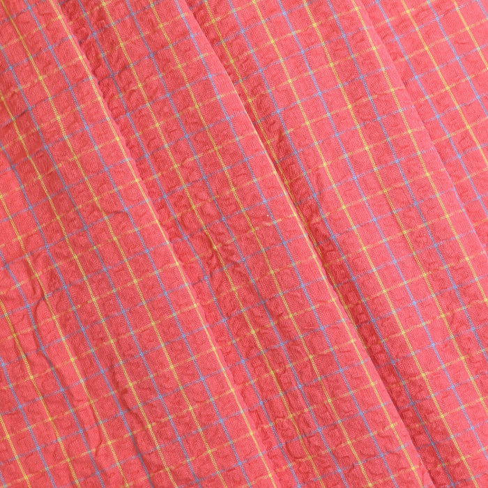 Coral checked cotton seersucker fabric folded