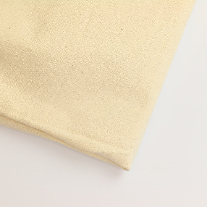 Unbleached medium weight calico fabric folded