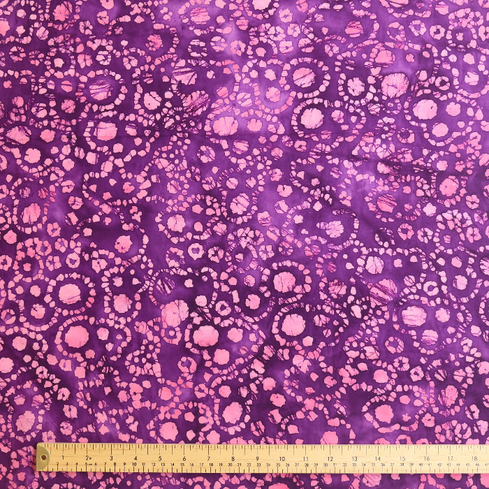 Purple and pink batik cotton fabric laid flat