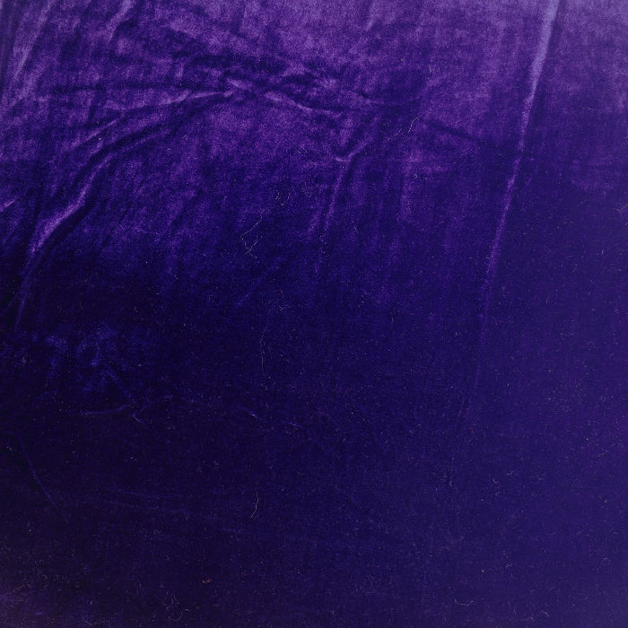 Deep purple crushed velvet fabric laid flat
