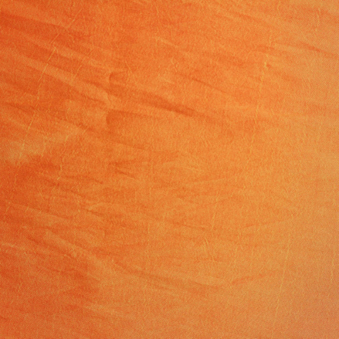 Orange gold faux silk shantung fabric laid flat