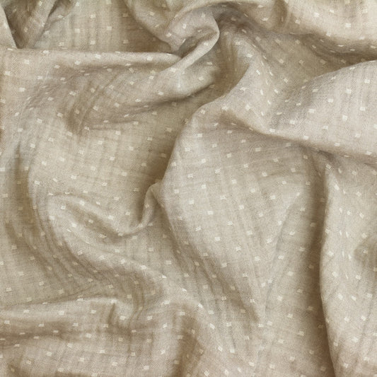 Close-up of beige fabric with subtle pattern