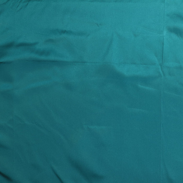 Peacock teal satin fabric laid flat