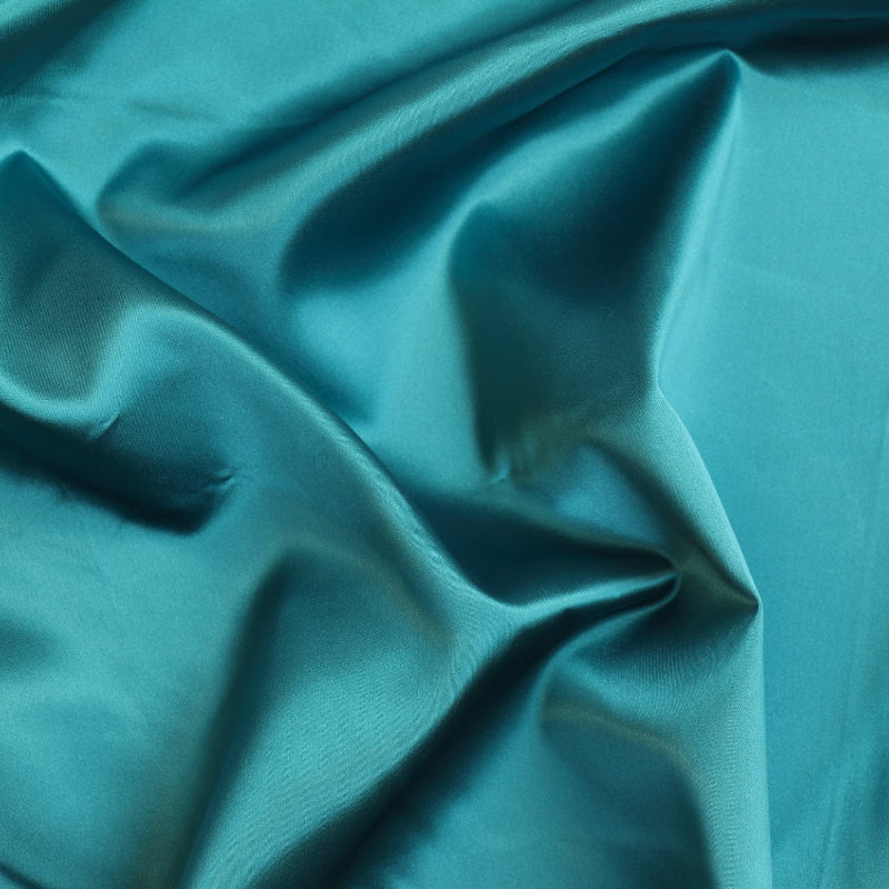 Peacock teal satin fabric showing drape