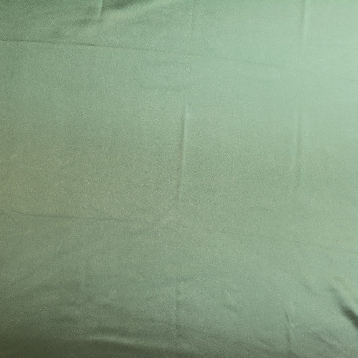 Sage green charmeuse satin fabric laid flat