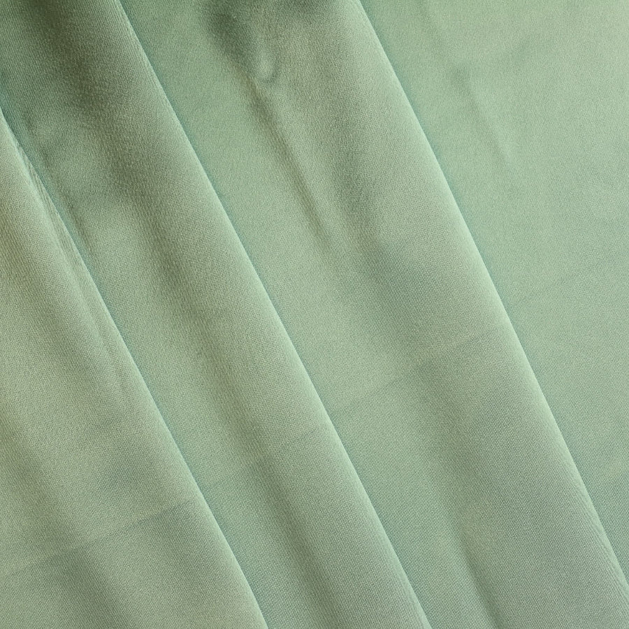 Sage green charmeuse satin fabric folded