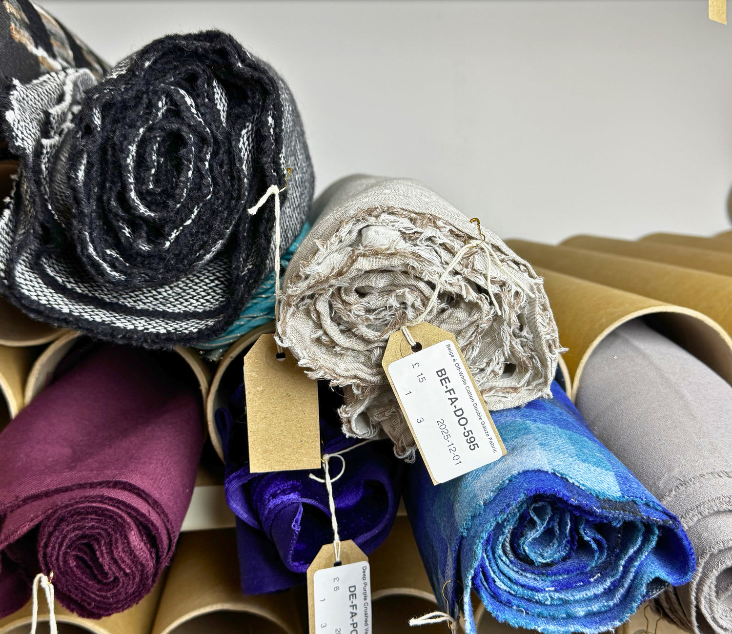 Rolls of pre-loved sewing and dressmaking fabrid ready for sale